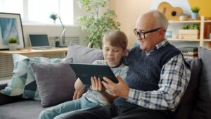 grandfather and grandson looking at a tablet