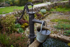 old fashioned pump with water bucket