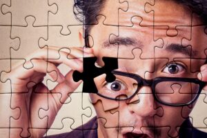 man's face on a puzzle, with one piece askew