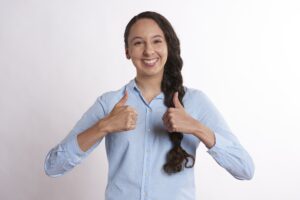 woman smiling with thumbs