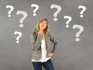 woman thinking with question marks in background