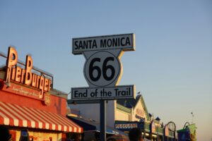 road sign that says "Santa Monica, 66, End of the Trail"