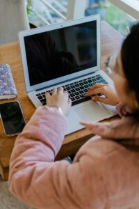 person typing at laptop