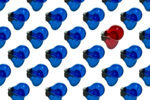 one set of red lightbulbs among multiple sets of blue lightbulbs