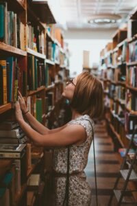 person in library looking for a book