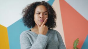 person with hand on chin, thinking