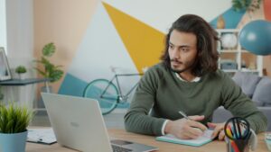 college student at desk with laptop